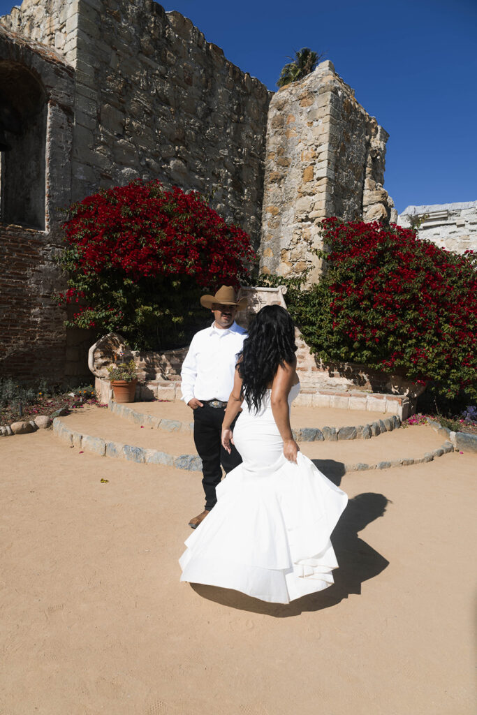 San Juan Capistrano engagement shoot with future bride and groom taking western style engagment photos at san juan capistrano mission