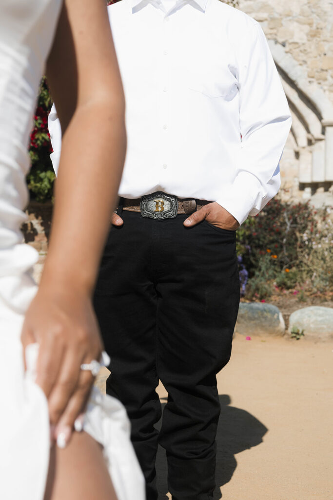 future bride and groom taking western style engagment photos at san juan capistrano mission