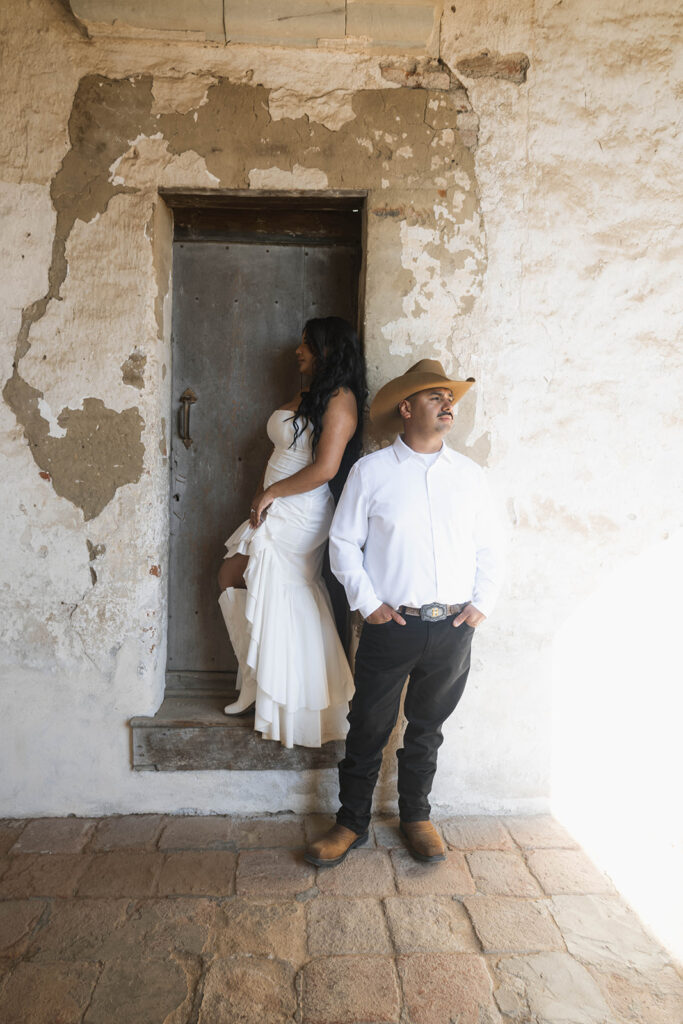 San Juan Capistrano engagement shoot with future bride and groom taking western style engagment photos at san juan capistrano mission