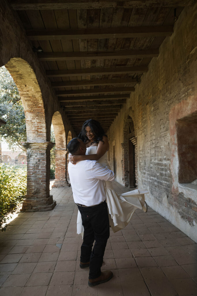 San Juan Capistrano engagement shoot with future bride and groom taking western style engagment photos at san juan capistrano mission