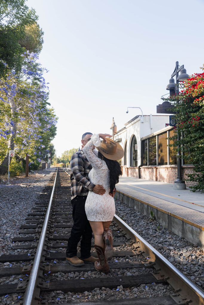 fiance with groom to be in front of historic architecture and train tracks