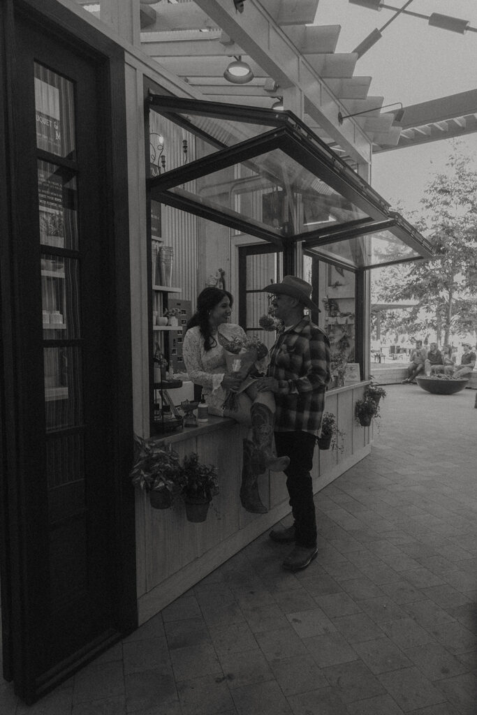 San Juan Capistrano engagement shoot future bride and groom taking photos at local flower shop
