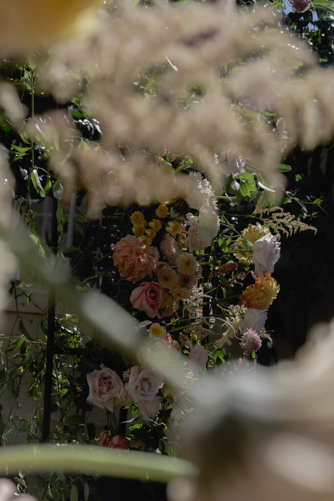 floral wedding details at an arch in courtyard
