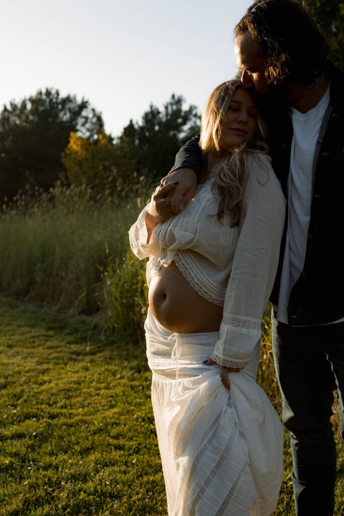 Orange County maternity photographer capturing organic couples maternity session in tall grass with expecting parents