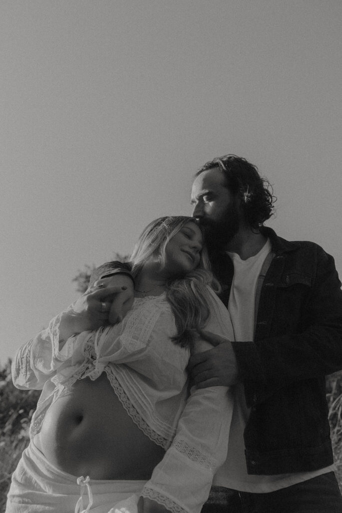 Orange County maternity photographer capturing organic couples maternity session in tall grass with expecting parents