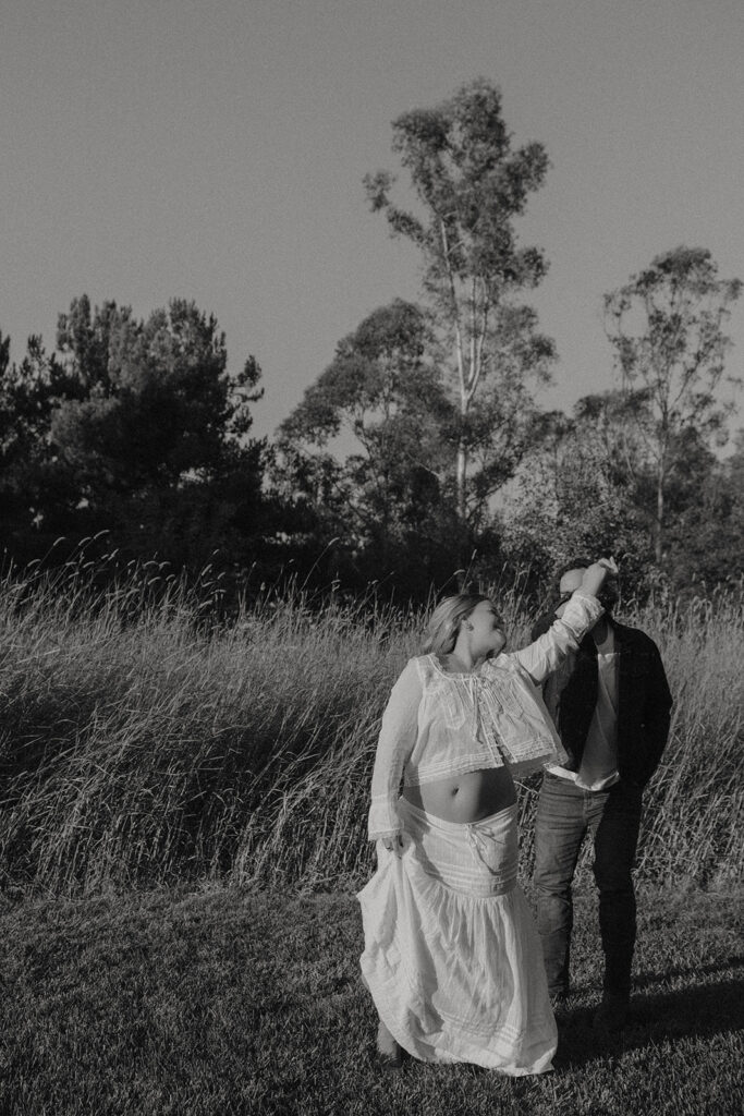Orange County maternity photographer capturing organic couples maternity session in tall grass with expecting parents