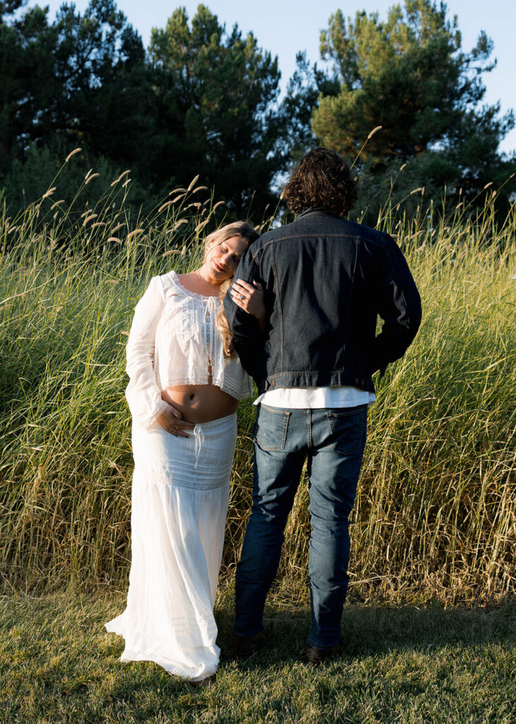 Orange County maternity photographer capturing organic couples maternity session in tall grass with expecting parents