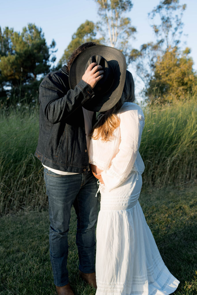 Orange County maternity photographer capturing organic couples maternity session in tall grass with expecting parents