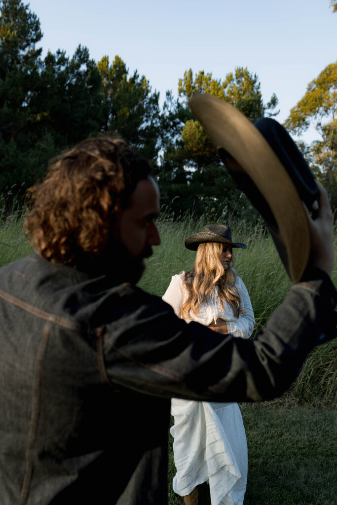Orange County maternity photographer capturing organic couples maternity session in tall grass with expecting parents
