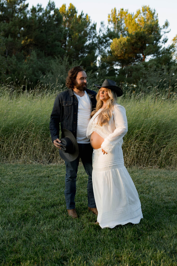 Orange County maternity photographer capturing organic couples maternity session in tall grass with expecting parents