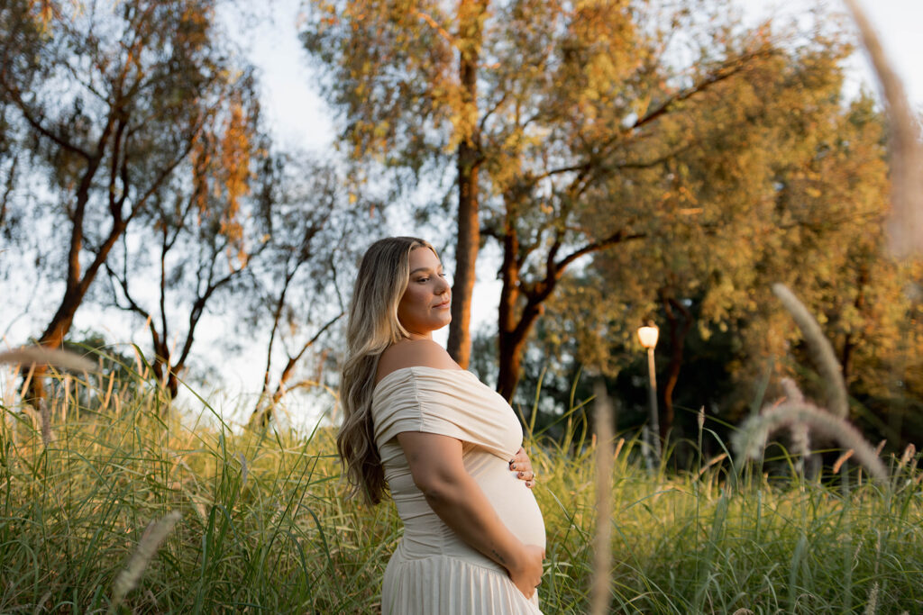 Orange County maternity photographer capturing organic couples maternity session in tall grass with expecting parents