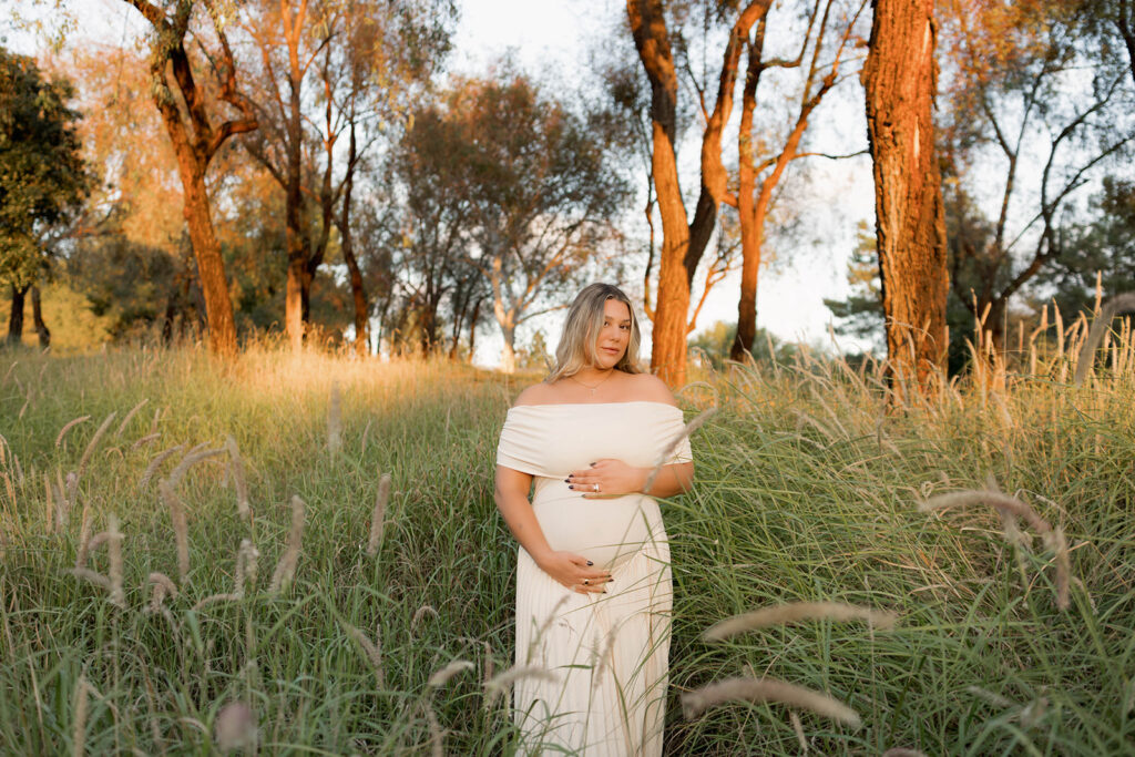 Orange County maternity photographer capturing organic couples maternity session in tall grass with expecting parents