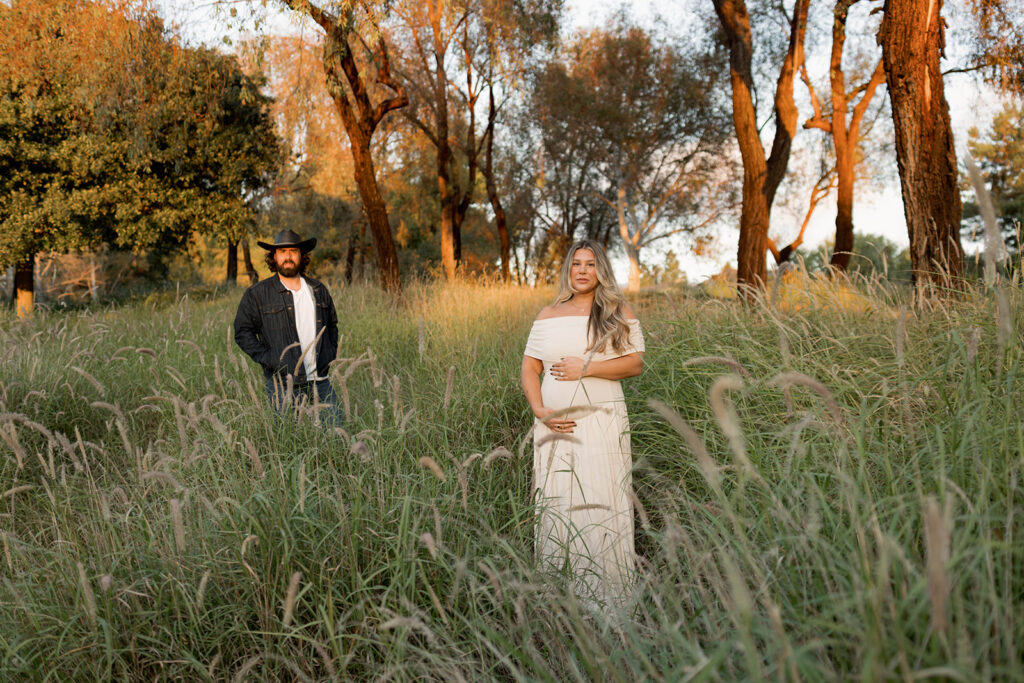 Orange County maternity photographer capturing organic couples maternity session in tall grass with expecting parents