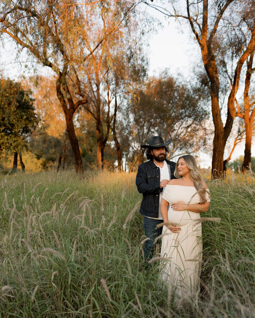 Orange County maternity photographer capturing organic couples maternity session in tall grass with expecting parents