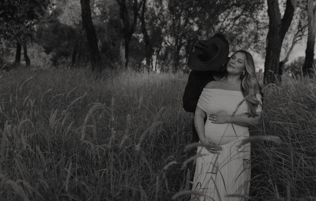 Orange County maternity photographer capturing organic couples maternity session in tall grass with expecting parents