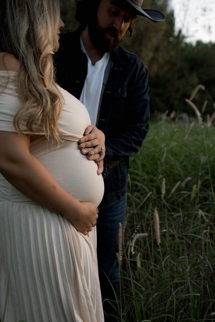 Orange County maternity photographer capturing organic couples maternity session in tall grass with expecting parents