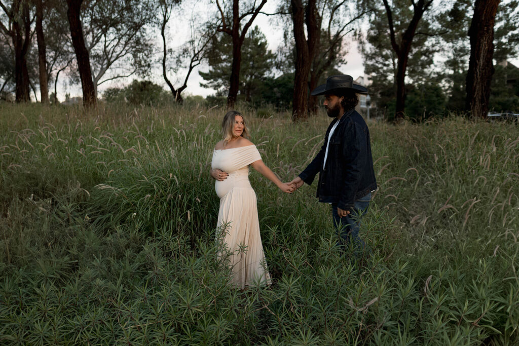 Orange County maternity photographer capturing organic couples maternity session in tall grass with expecting parents