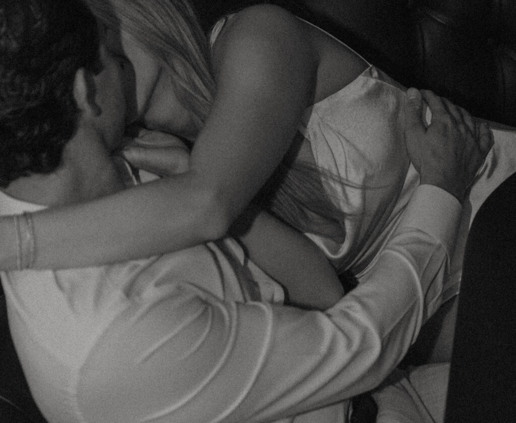 Cinematic engagement photography of couple laughing inside a cozy bar in Historic Orange