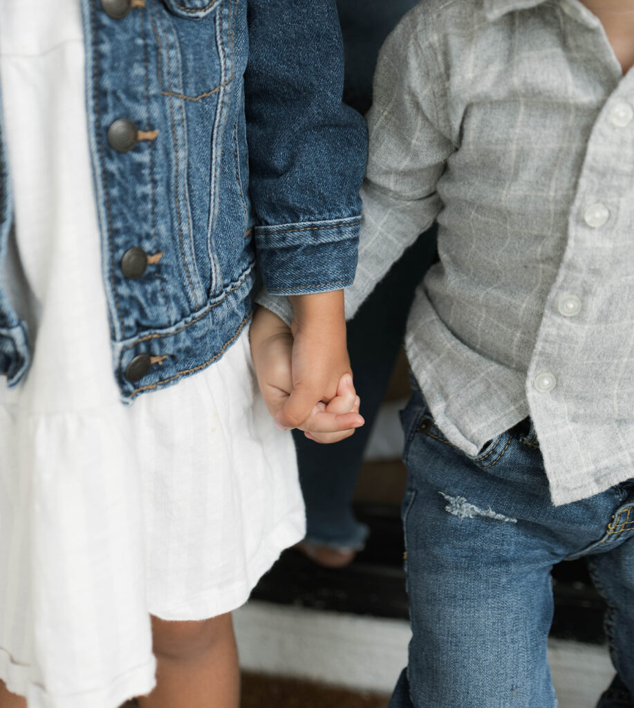 Young family of five standing in front of their forever home during an Orange County in-home family photography session