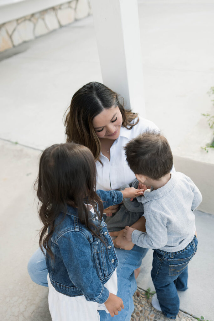 Young family of five standing in front of their forever home during an Orange County in-home family photography session