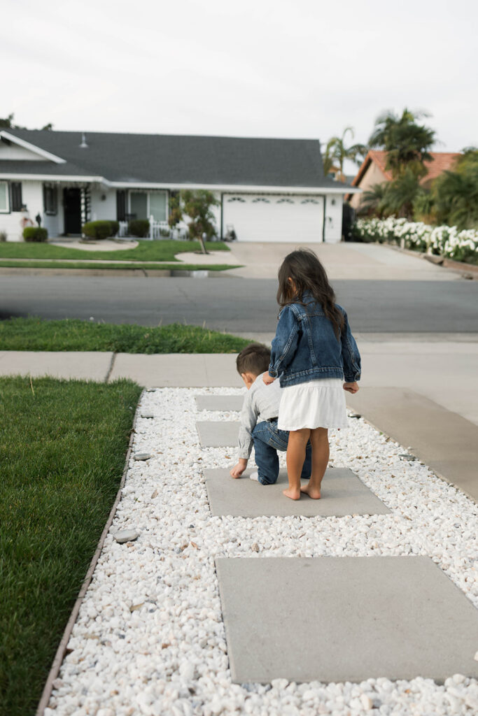 Young family of five standing in front of their forever home during an Orange County in-home family photography session