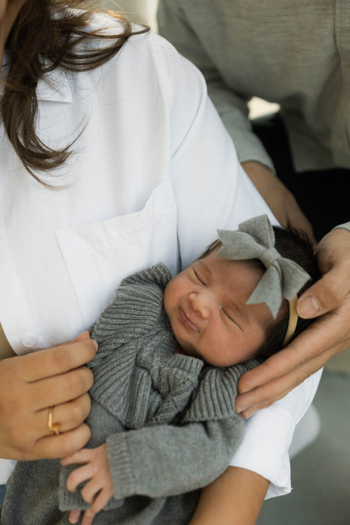Young family of five standing in front of their forever home during an Orange County in-home family photography session