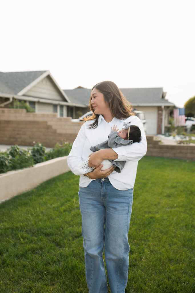Young family of five standing in front of their forever home during an Orange County in-home family photography session