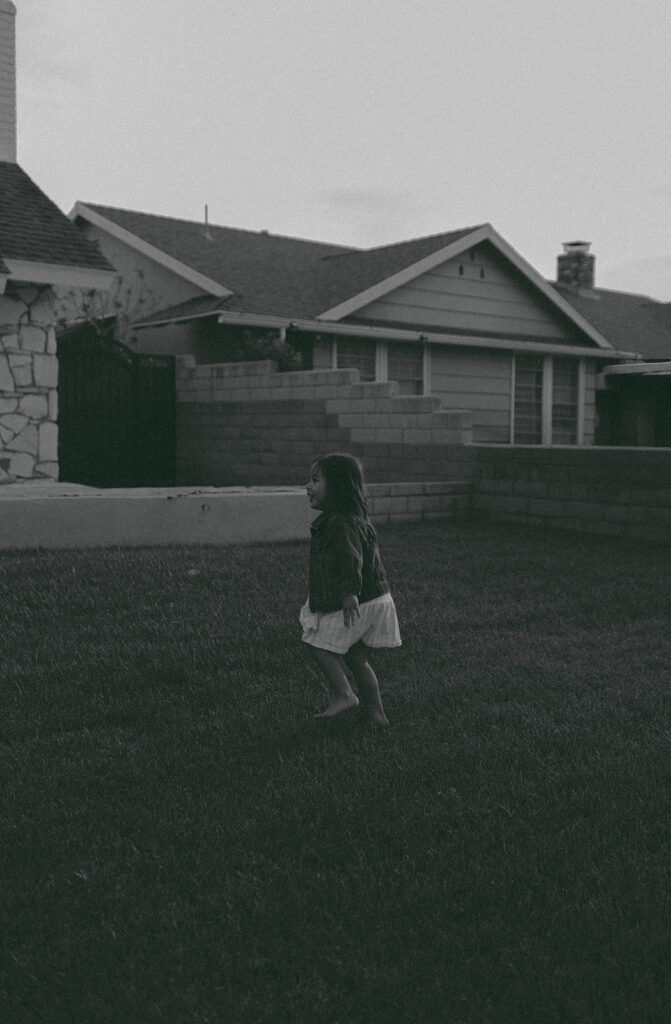 Young family of five standing in front of their forever home during an Orange County in-home family photography session