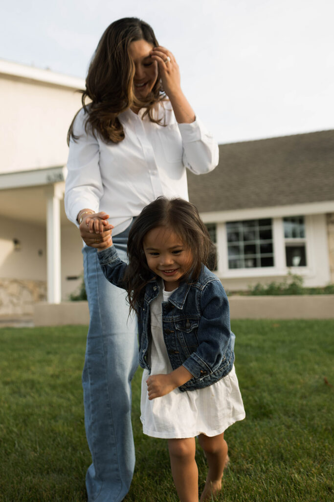 Young family of five standing in front of their forever home during an Orange County in-home family photography session