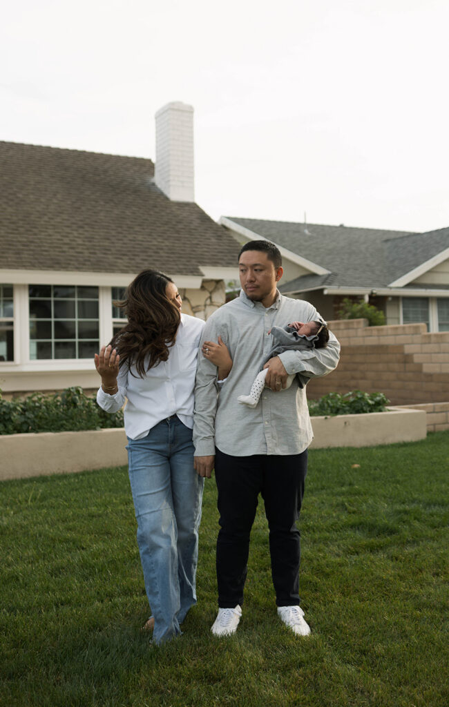 Young family of five standing in front of their forever home during an Orange County in-home family photography session