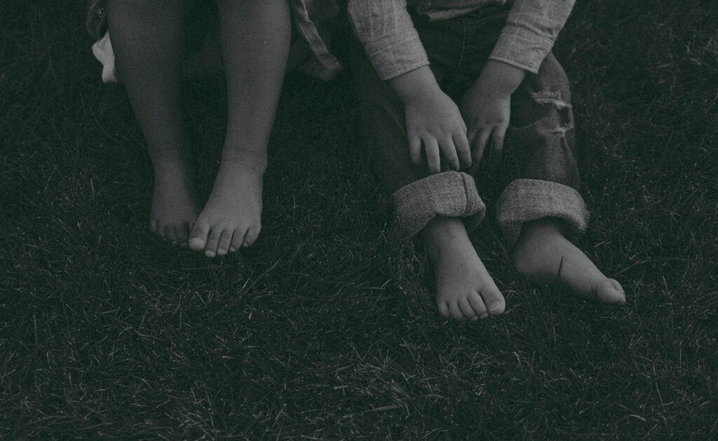 Young family of five standing in front of their forever home during an Orange County in-home family photography session