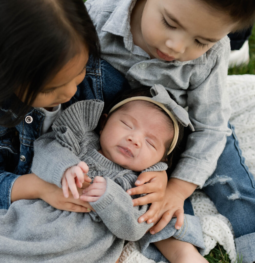 Young family of five standing in front of their forever home during an Orange County in-home family photography session