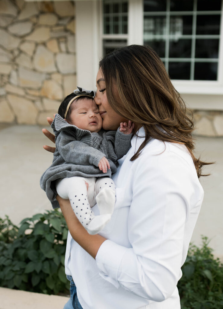 Young family of five standing in front of their forever home during an Orange County in-home family photography session