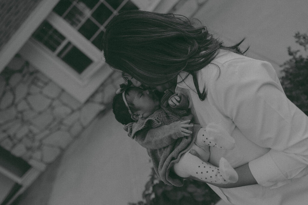 Young family of five standing in front of their forever home during an Orange County in-home family photography session