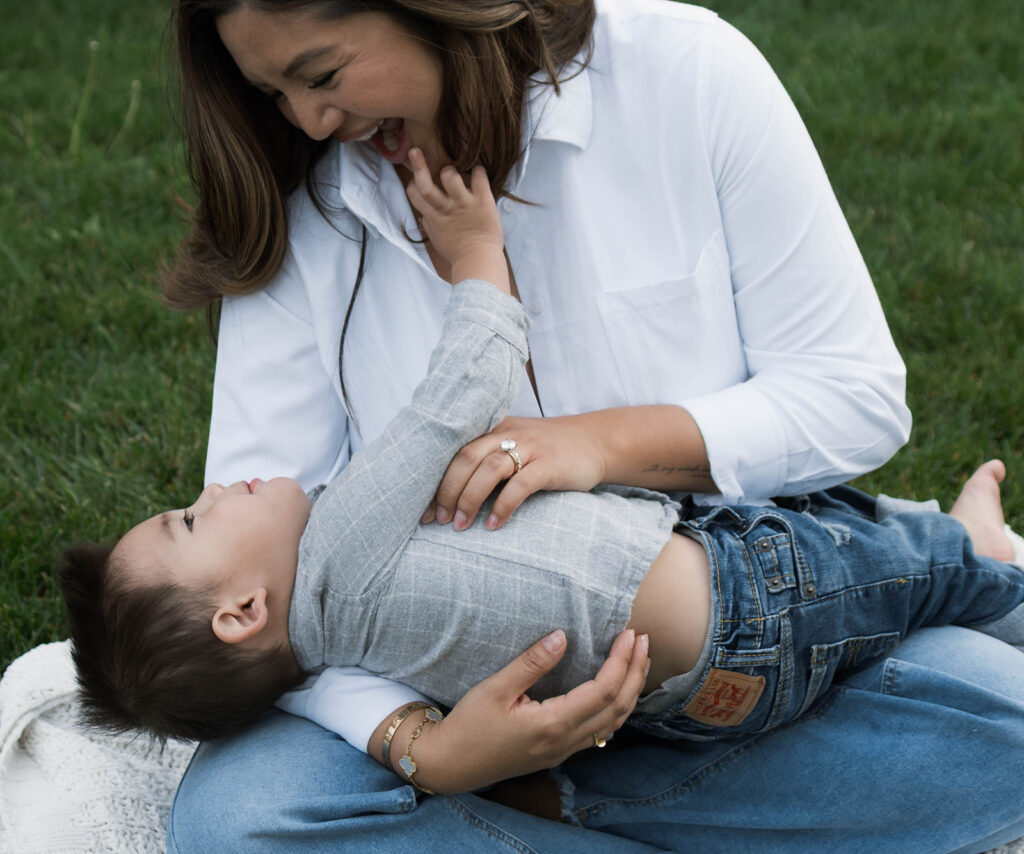 Young family of five standing in front of their forever home during an Orange County in-home family photography session