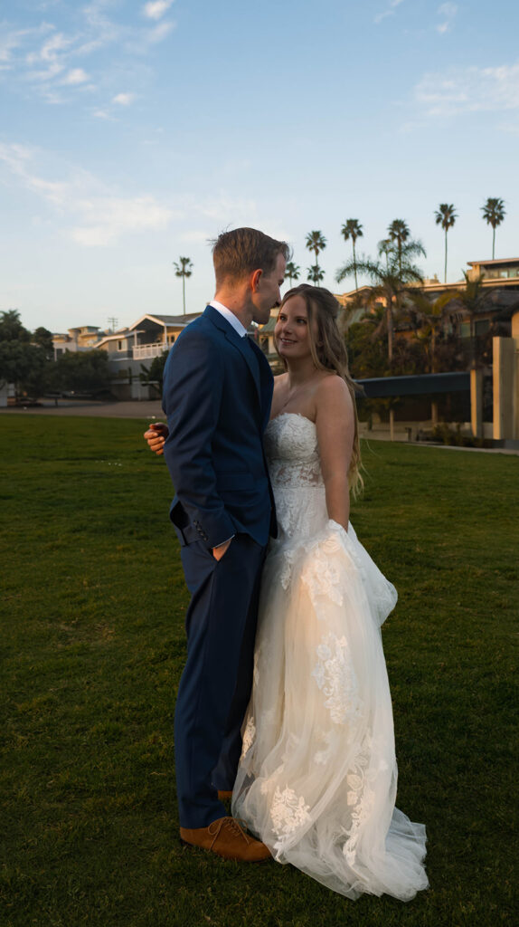 Intimate beach elopement ceremony with family gathered on a cliffside