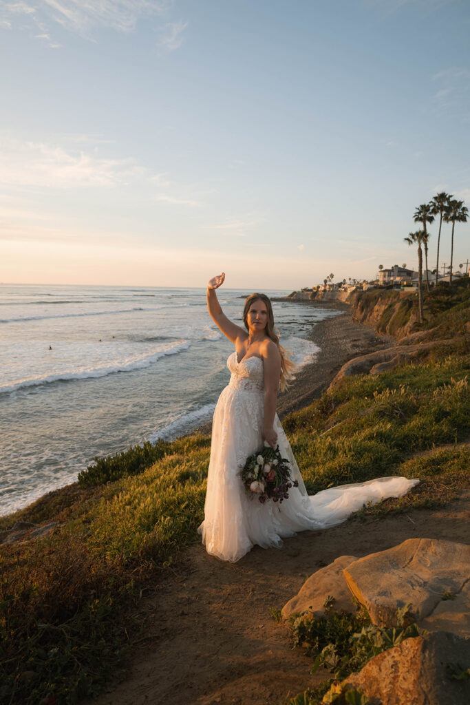 Intimate beach elopement ceremony with family gathered on a cliffside