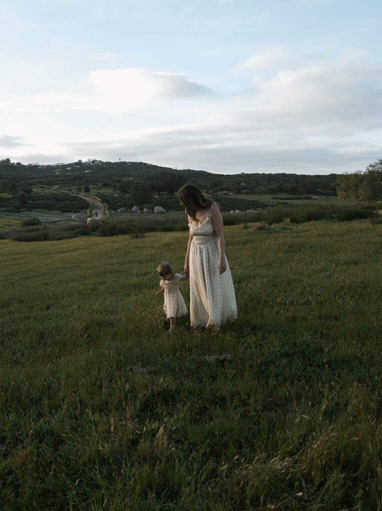 Candid moment of parents and child embracing in golden hour light