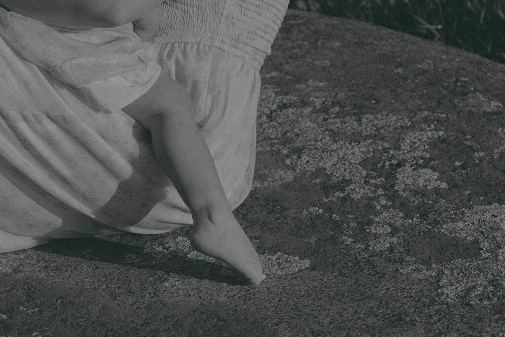 Candid moment of parents and child embracing in golden hour light