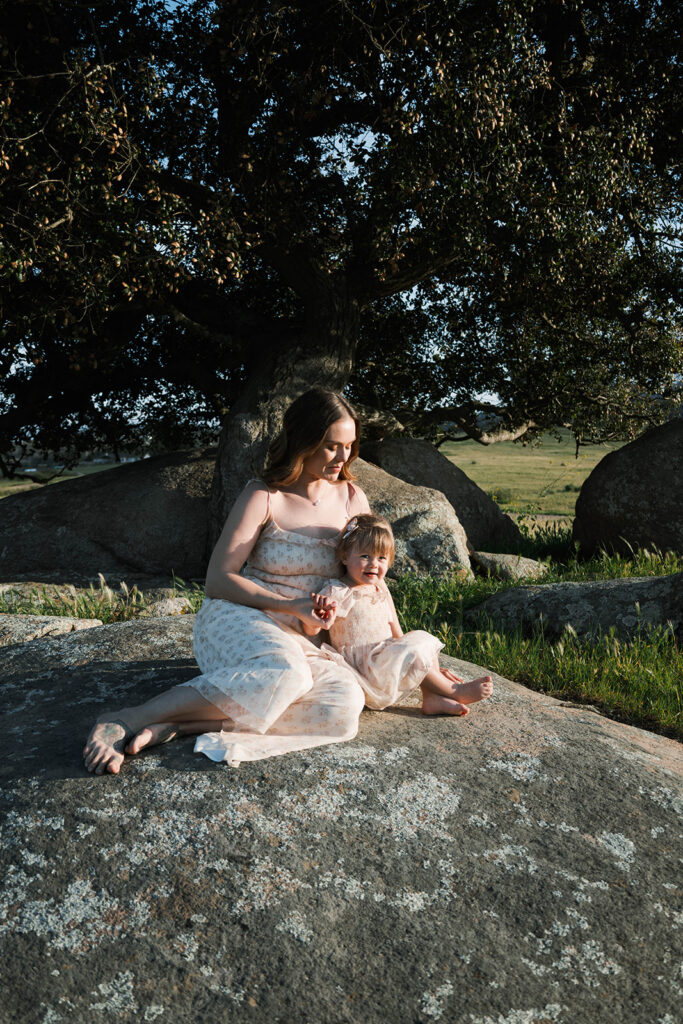 Candid moment of parents and child embracing in golden hour light