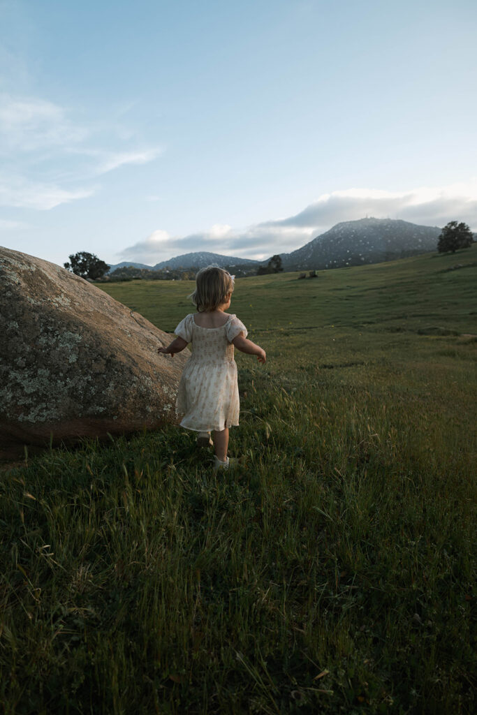 Candid moment of parents and child embracing in golden hour light