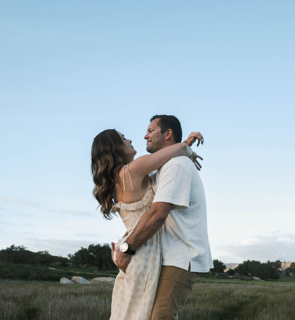 Candid moment of parents and child embracing in golden hour light