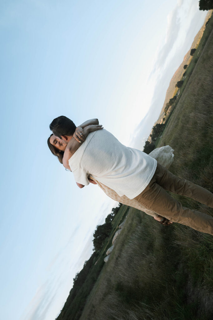 Candid moment of parents and child embracing in golden hour light