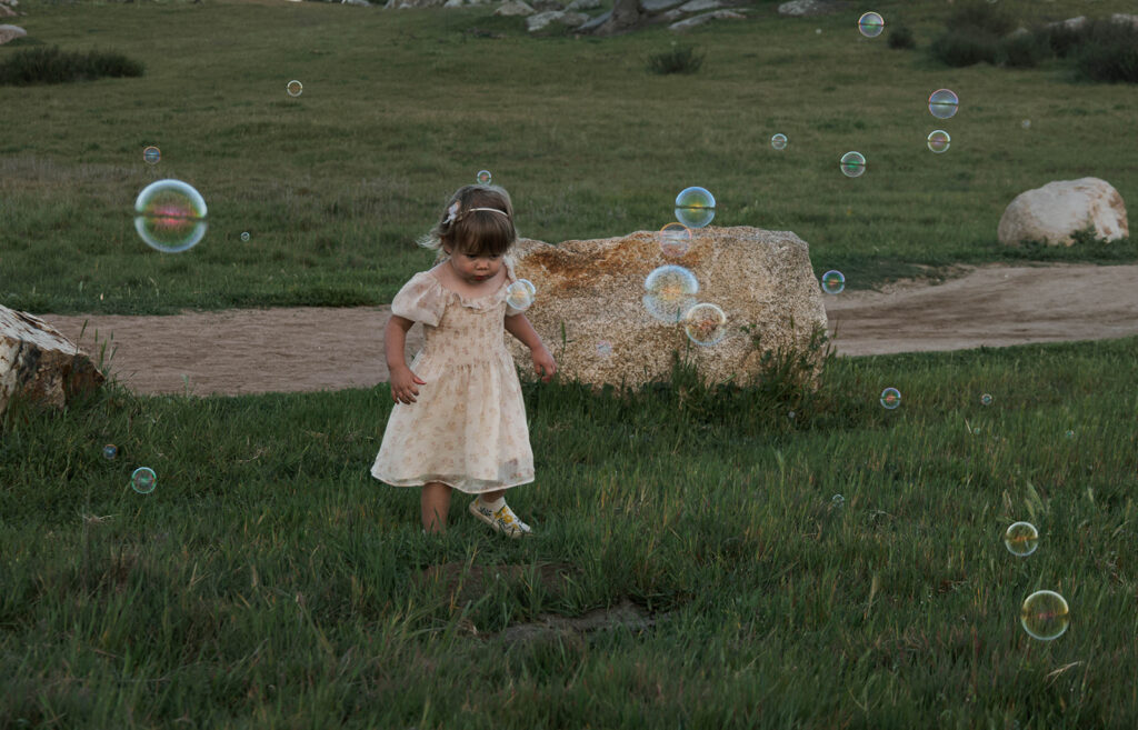 Candid moment child embracing in golden hour light with bubbles