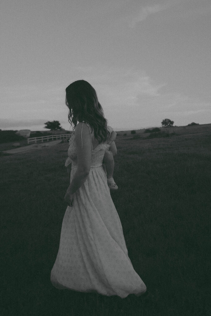 Candid moment of parents and child embracing in golden hour light