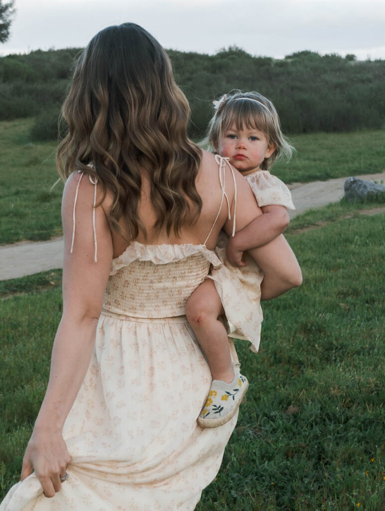 Candid moment of parents and child embracing in golden hour light