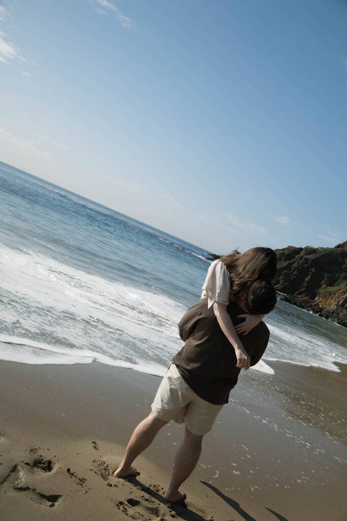 Cinematic film inspired engagement photos in Laguna Beach with Arizona couple in neutral outfits