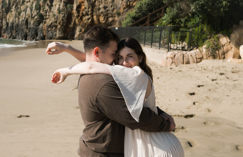 Cinematic film inspired engagement photos in Laguna Beach with Arizona couple in neutral outfits