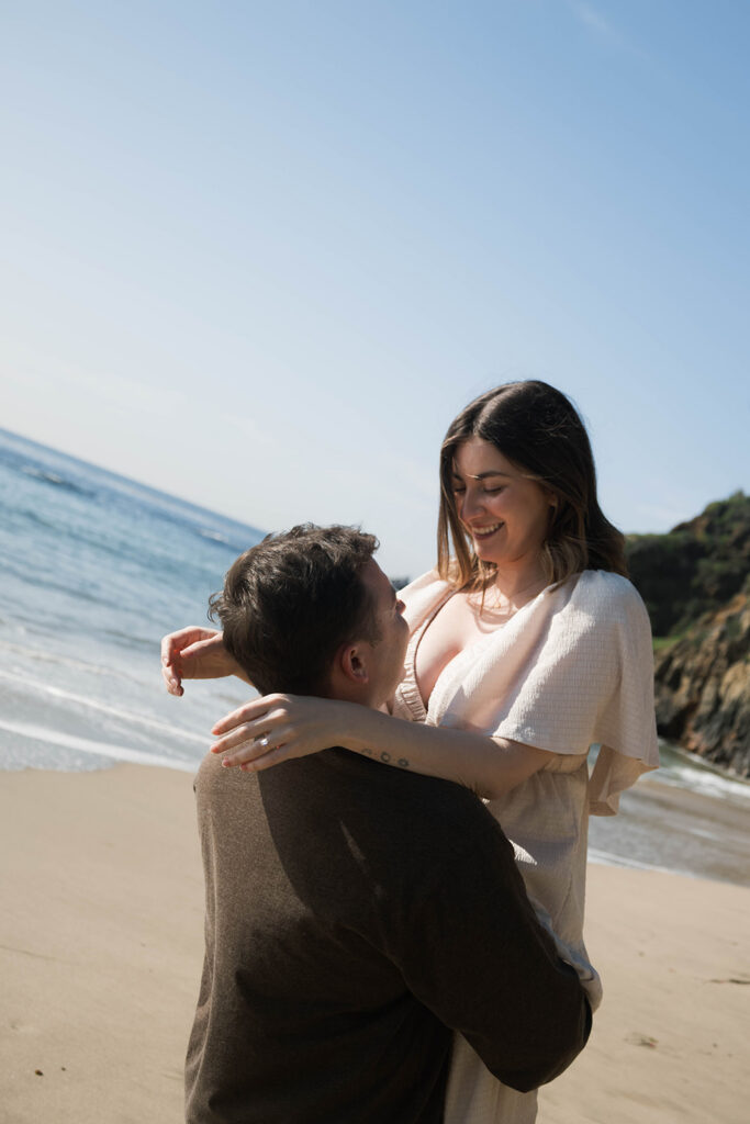 Cinematic film inspired engagement photos in Laguna Beach with Arizona couple in neutral outfits