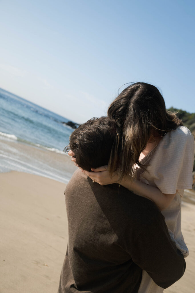 Cinematic film inspired engagement photos in Laguna Beach with Arizona couple in neutral outfits